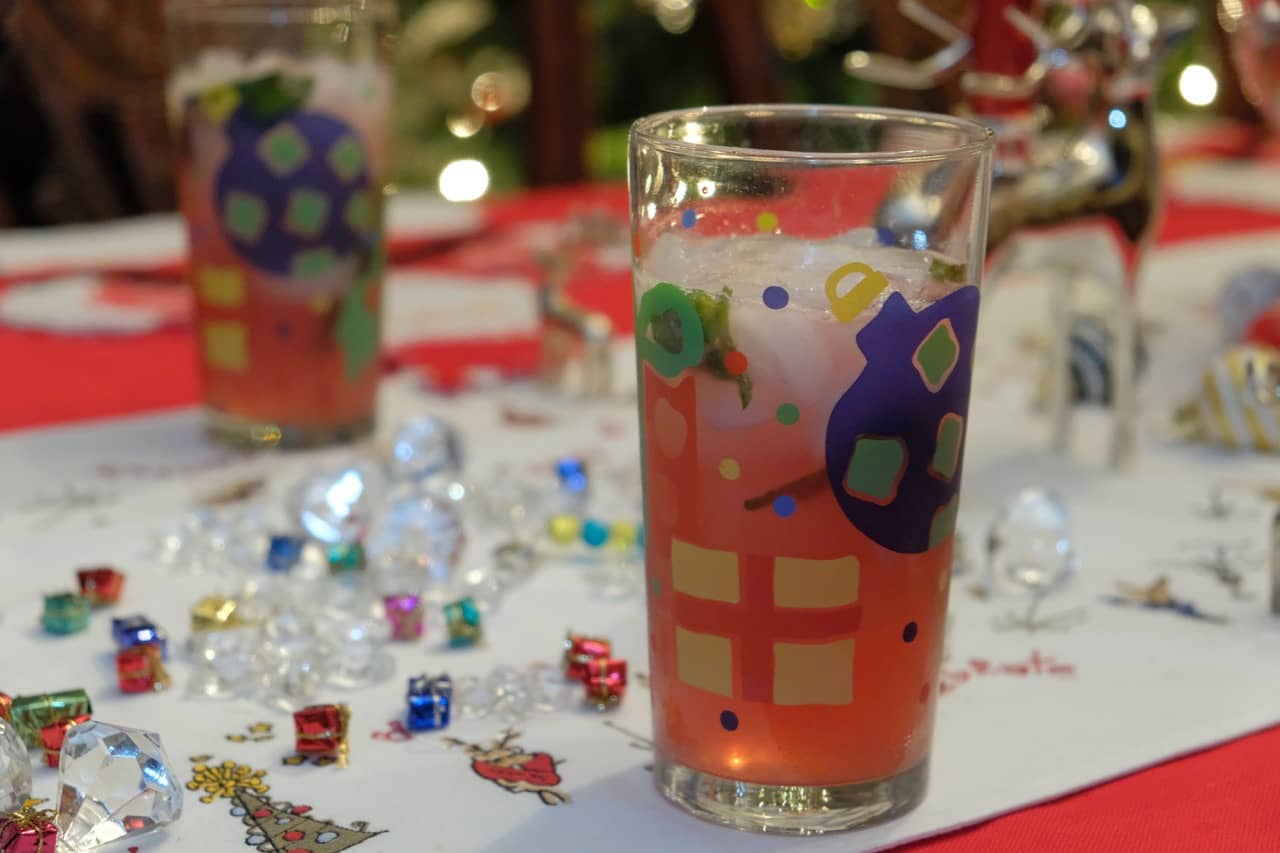 cranberry mojito in holiday themed glass on dinner table