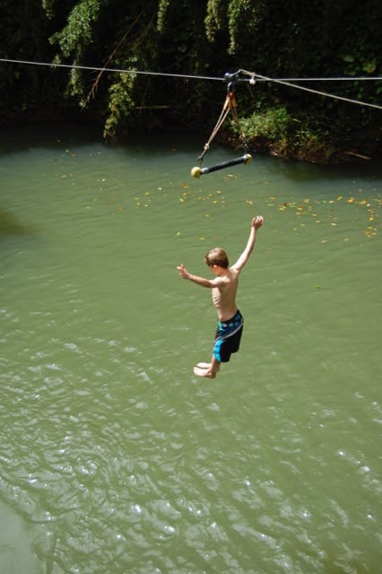 boy jumping into lagoon